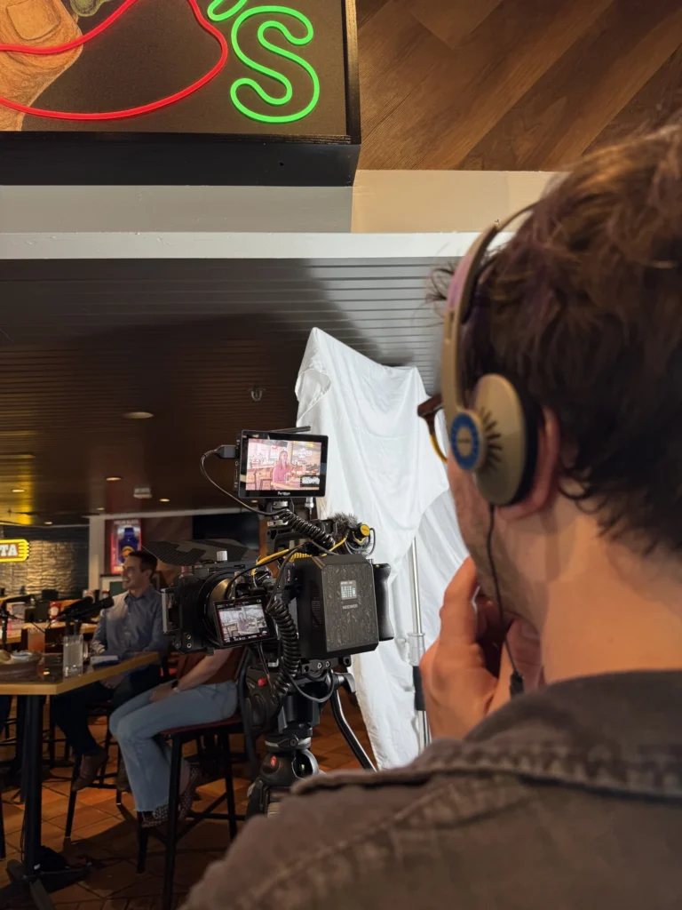 Man looking into camera while filming